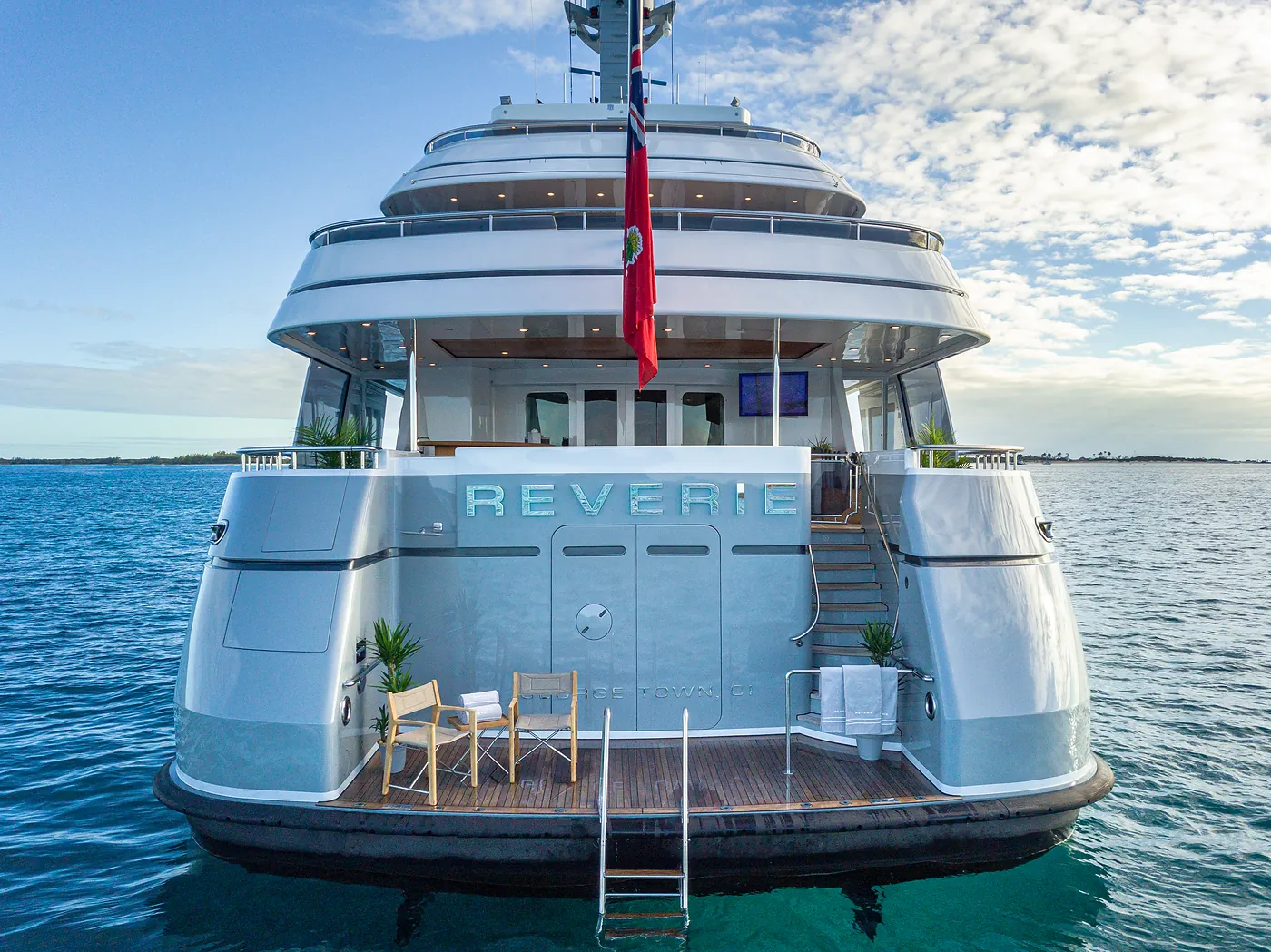 Reverie’s stern from the water: her name on the transom, the swim platform, and the ensign
